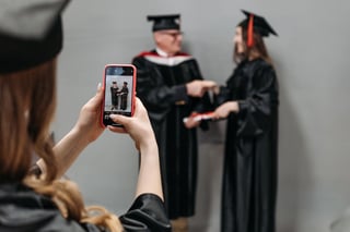 Graduate taking a photo with a smartphone during the ceremony