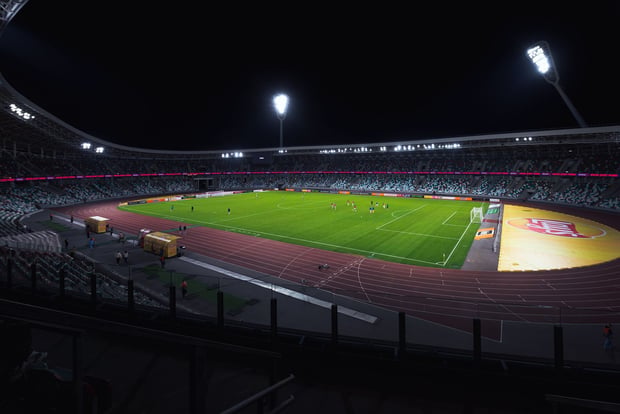 Floodlit football stadium at night