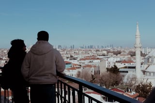 Couple looking out over a city from a railing