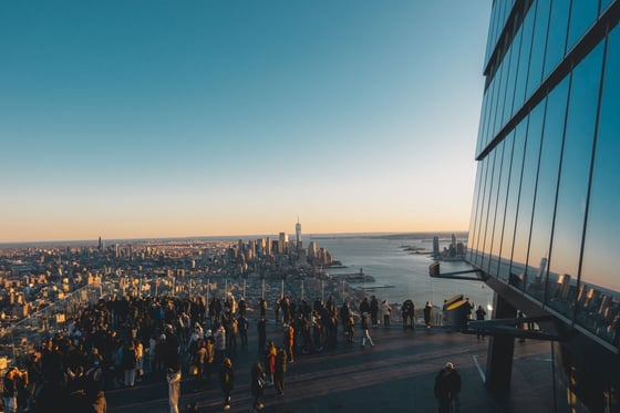 Crowd on a rooftop observation deck at sunset