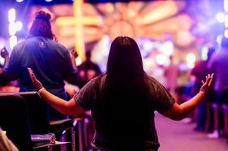 Congregation at a worship service under stage lights