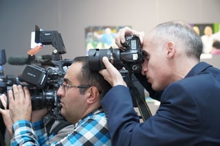 Photographers covering an indoor event