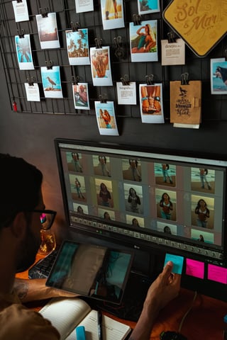 Editor reviewing photos on two monitors