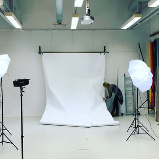Photographer setting up a studio backdrop