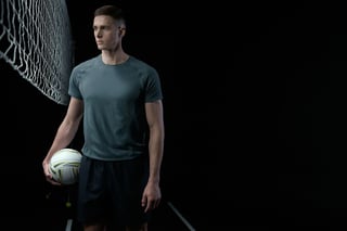 Adult volleyball player holding a ball in a studio