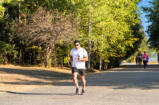 Runner on a tree-lined road during a race
