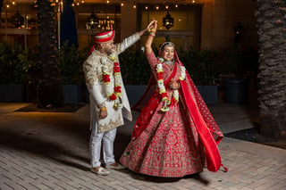 Couple dancing under lights at their wedding