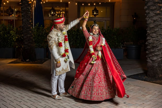 Couple dancing under lights at their wedding