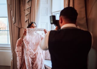 Wedding photographer photographing a bride in traditional clothing