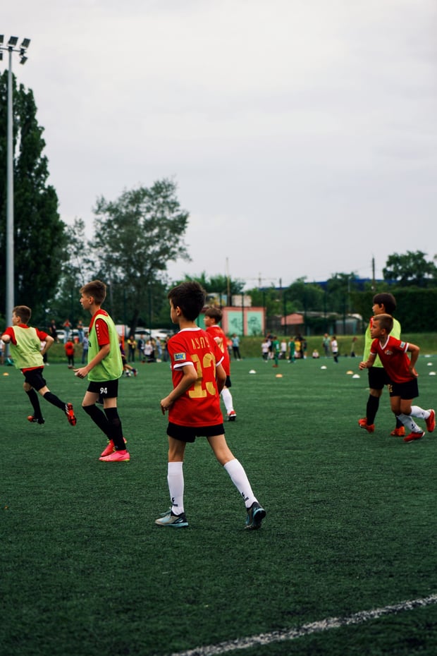 Youth soccer team warming up in numbered jerseys