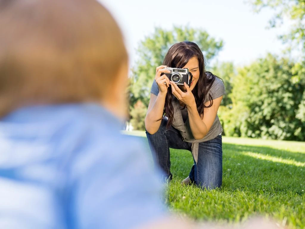 photo of a photographer clicking a baby's photo