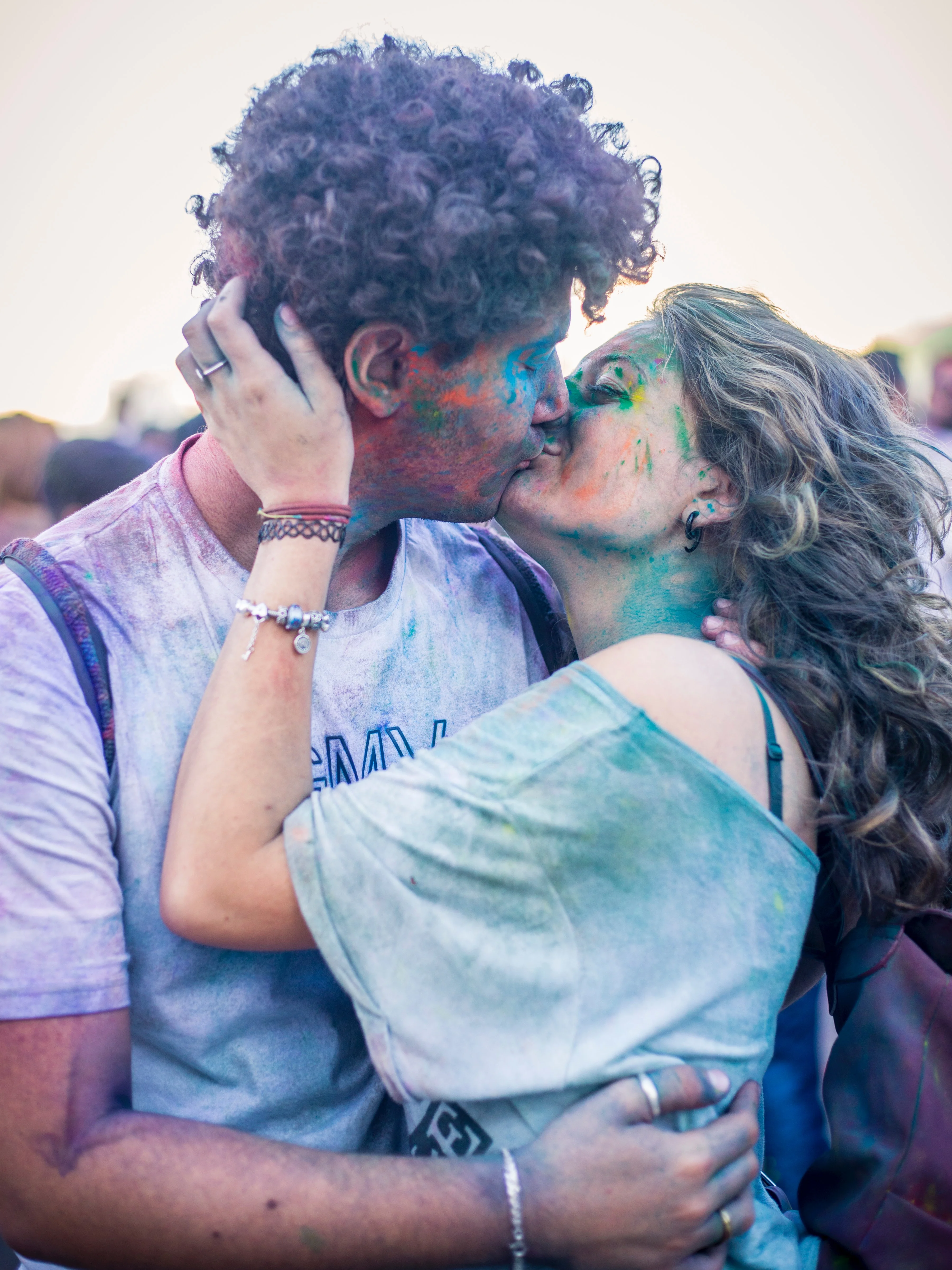 Couple Kissing while covered on paint