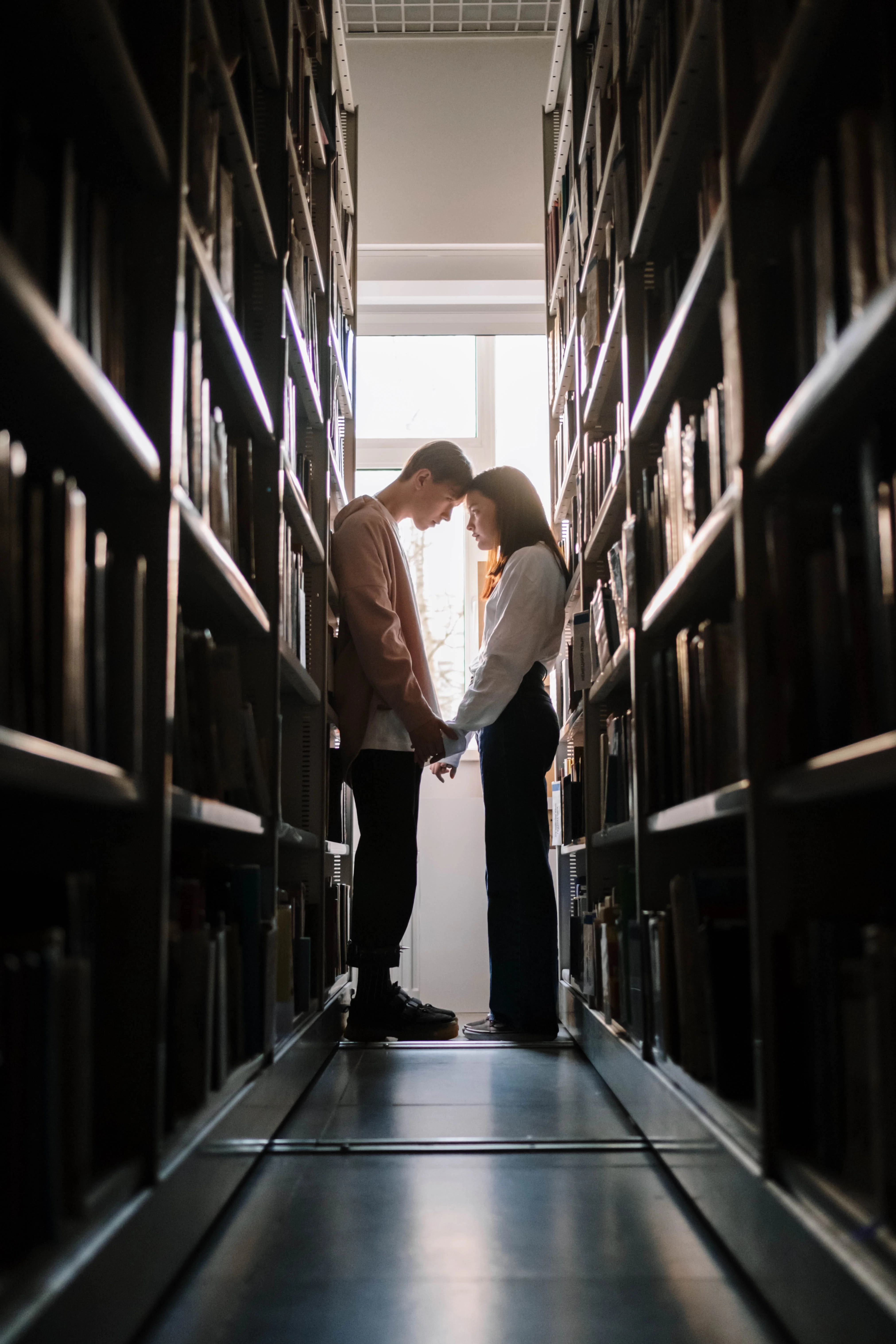 Couple on Library pressing foreheads