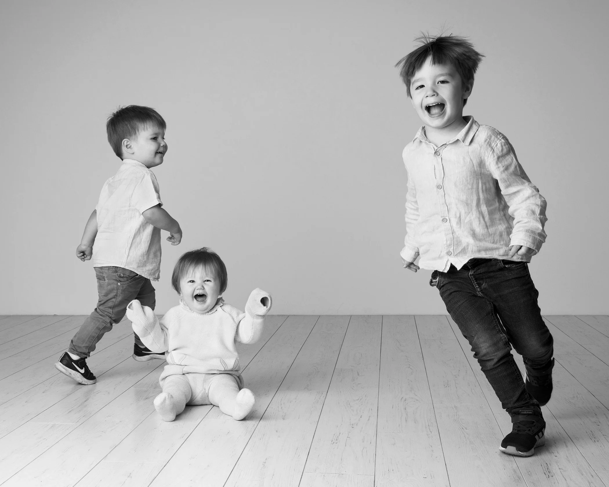 Black and white portrait of kids running