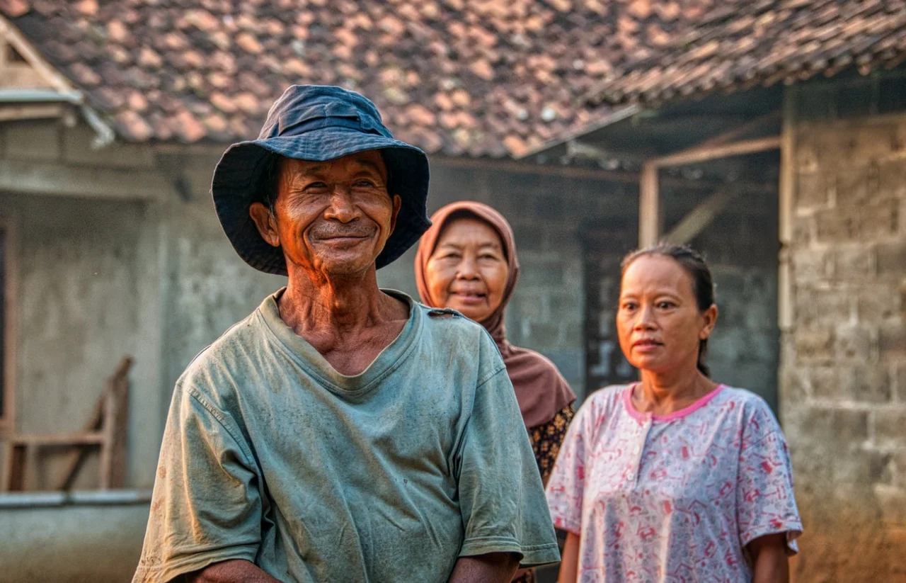 A photograph featuring warm, natural glowing colors of a man and two women