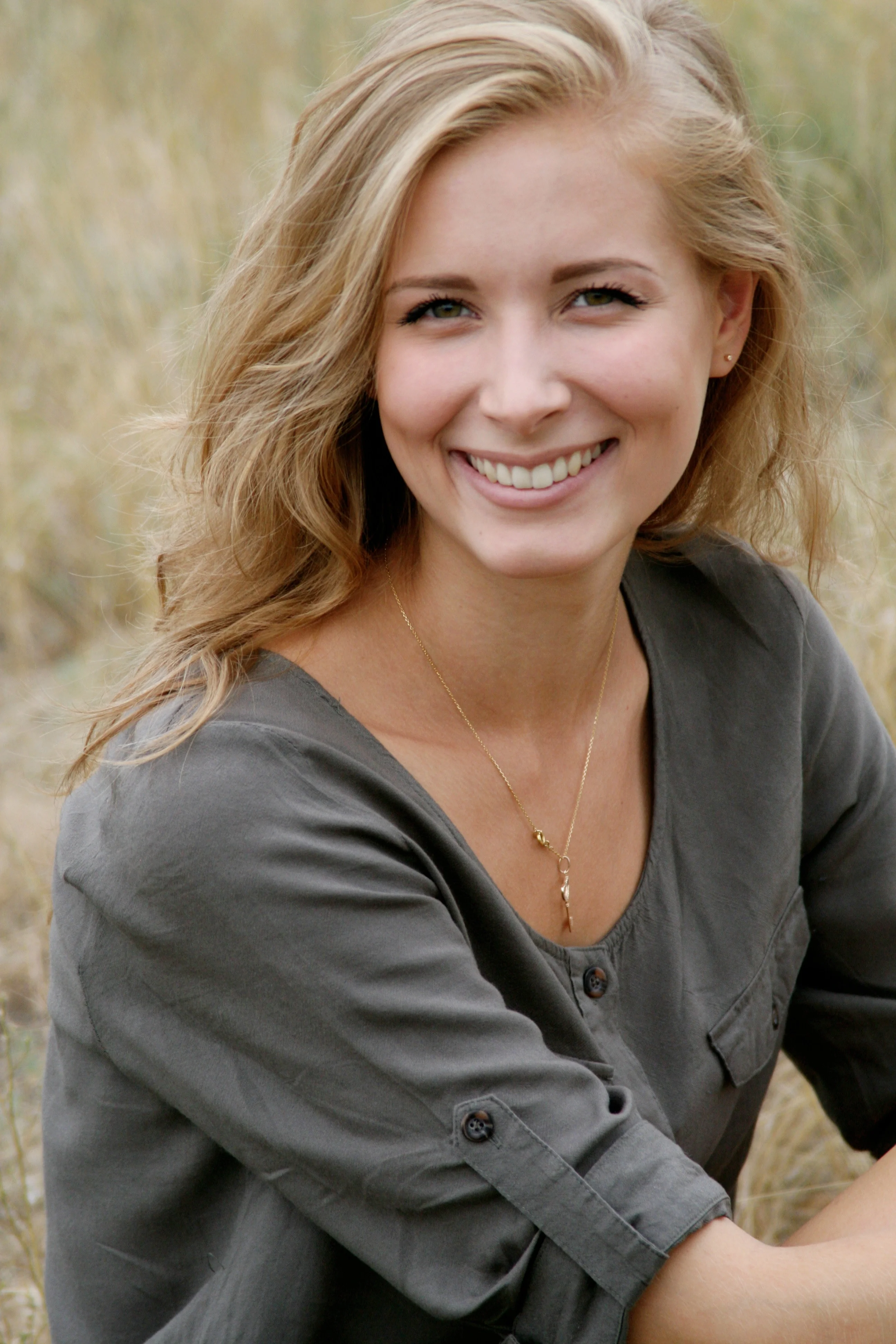 a photograph of a smiling blonde hair woman