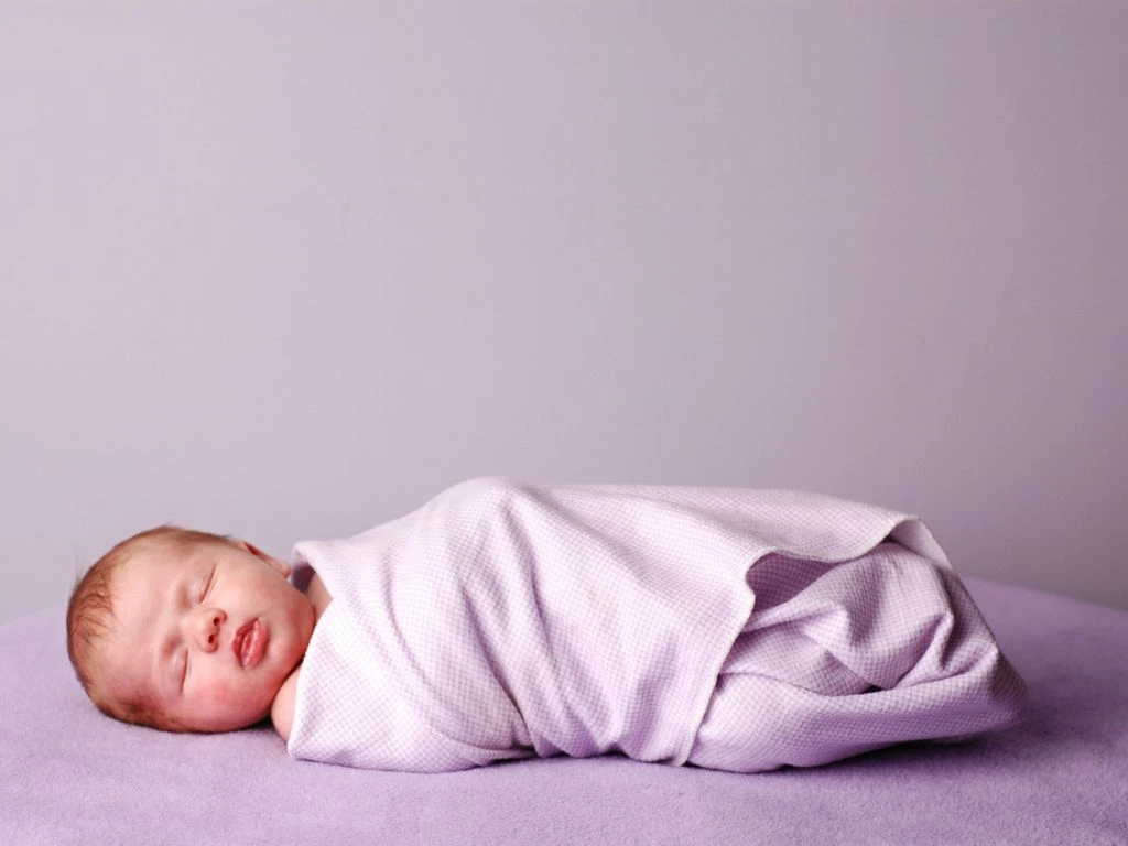 photo of a baby in pink background