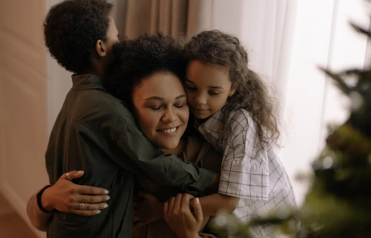 Woman hugging her daughter and son